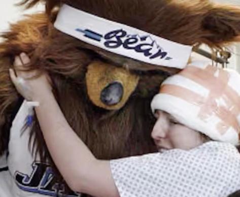 Jon Absey, as the Jazz Bear, hugs a patient at Primary Children's Hospital.