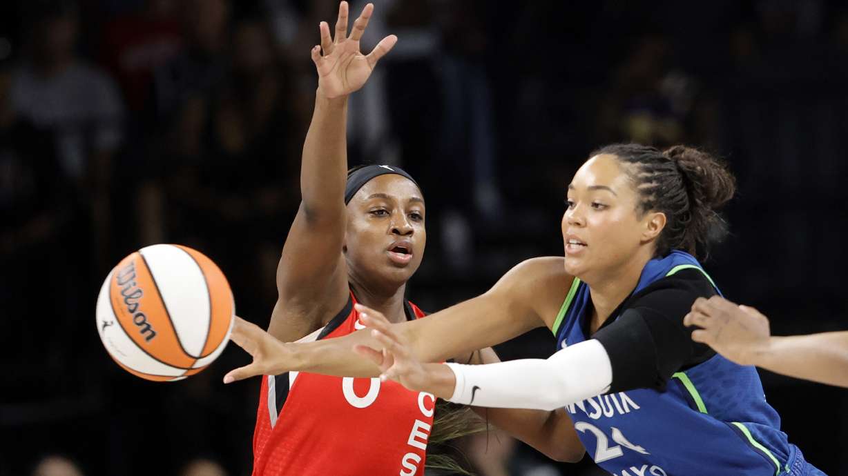 Las Vegas Aces guard Jackie Young (0) defends against Minnesota Lynx forward Napheesa Collier (24) during the first half of a WNBA basketball game Saturday, Aug. 2, 2025, in Las Vegas.