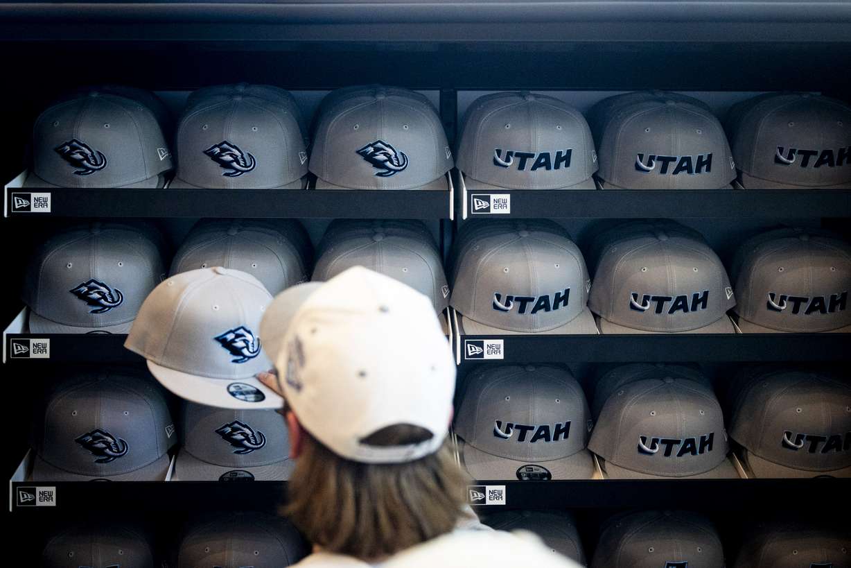 A person shops Utah Mammoth hats in the team store after a press conference announcing the Utah Hockey Club was changing its name to Utah Mammoth, at the Delta Center in Salt Lake City on May 7.