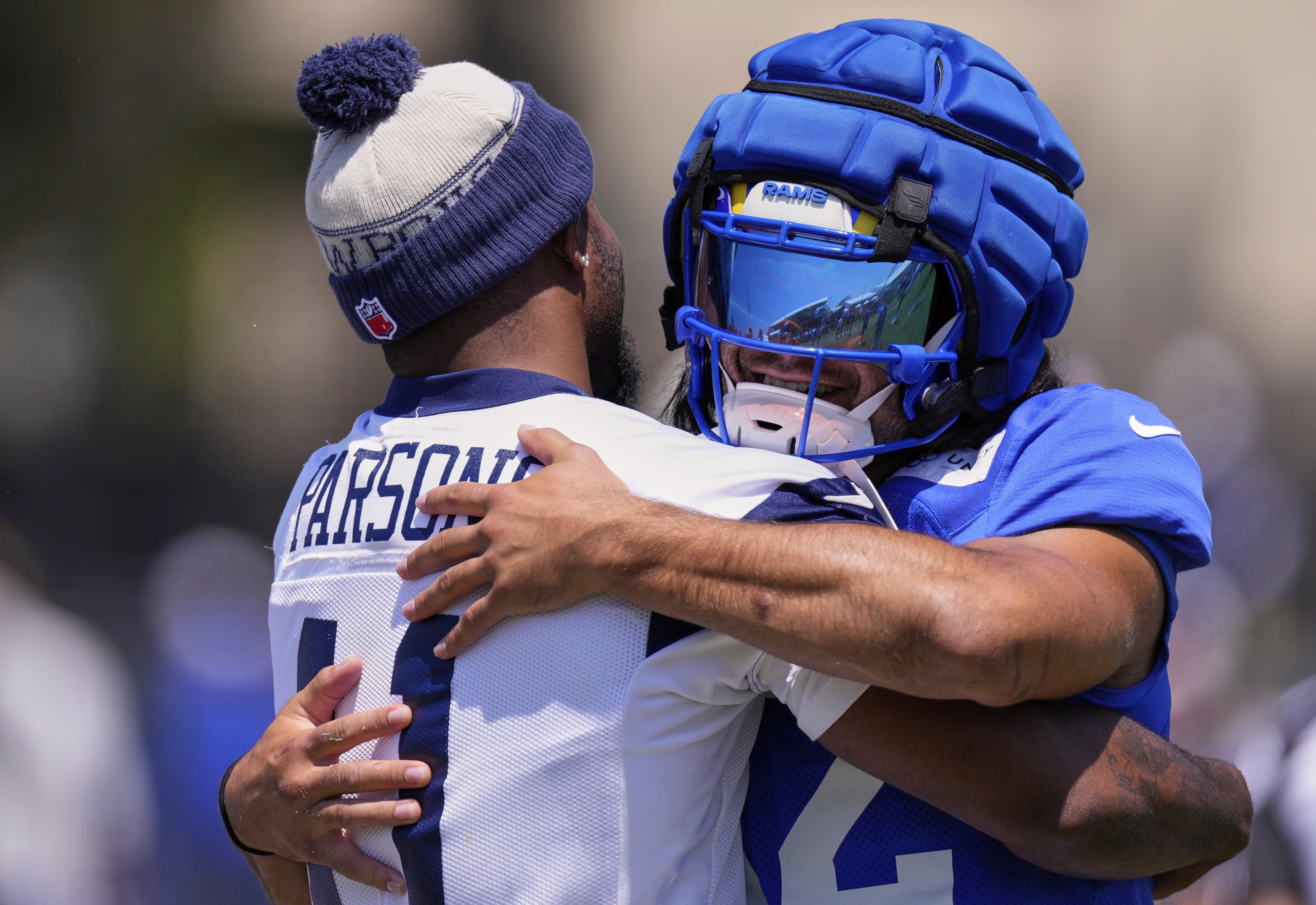 Dallas Cowboys defensive end Micah Parsons, left, and Los Angeles Rams wide receiver Puka Nacua greet each other during a training camp scrimmage, Tuesday, Aug. 5, 2025, in Oxnard, Calif.