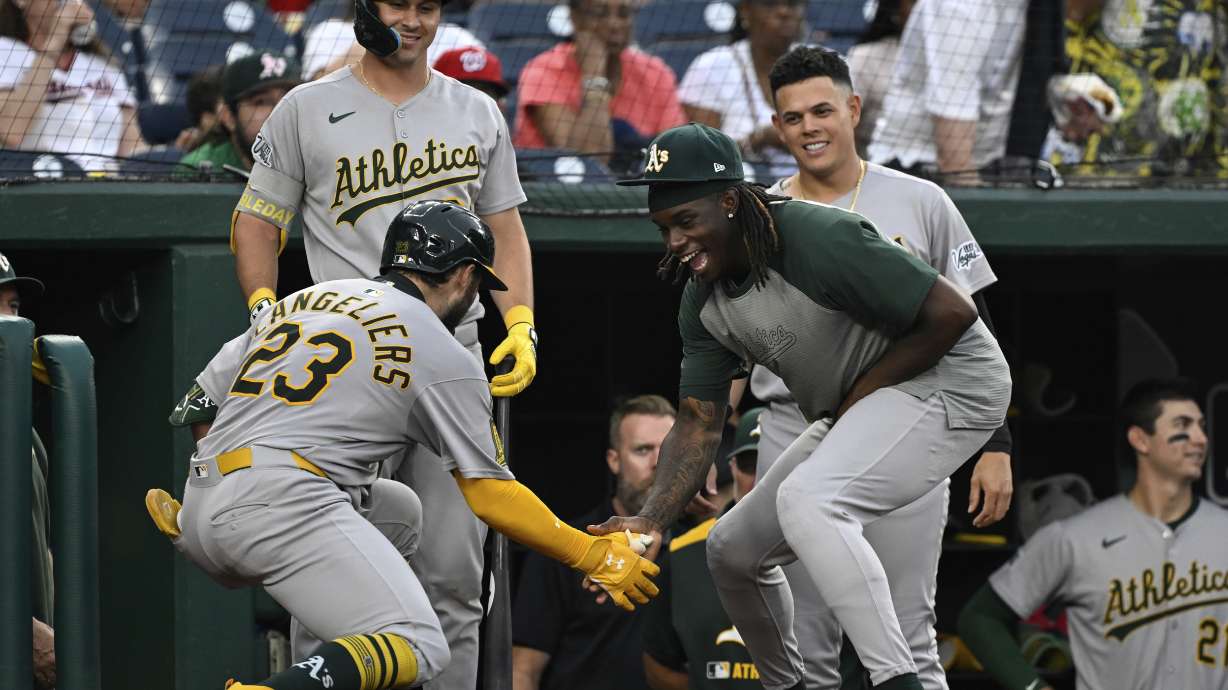 Athletics' Shea Langeliers (23) is greeted by Lawrence Butler, right, after hitting a home run against Washington Nationals pitcher MacKenzie Gore during the first inning of a baseball game in Washington, Tuesday, Aug. 5, 2025.