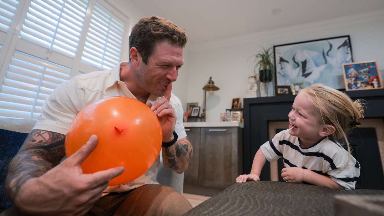 Kiri Duke-Rosati, 3, smiles at his father, Anthony, while they play in their Holladay home on Monday. Kiri has cerebral adrenoleukodystrophy, and his family is searching for a bone marrow donor for a transplant that may save his life.
