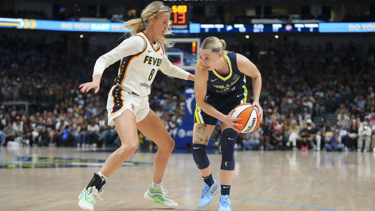 Dallas Wings guard Paige Bueckers, right, works the floor against Indiana Fever guard Sophie Cunningham during the second half of a WNBA basketball game Friday, Aug. 1, 2025, in Dallas.