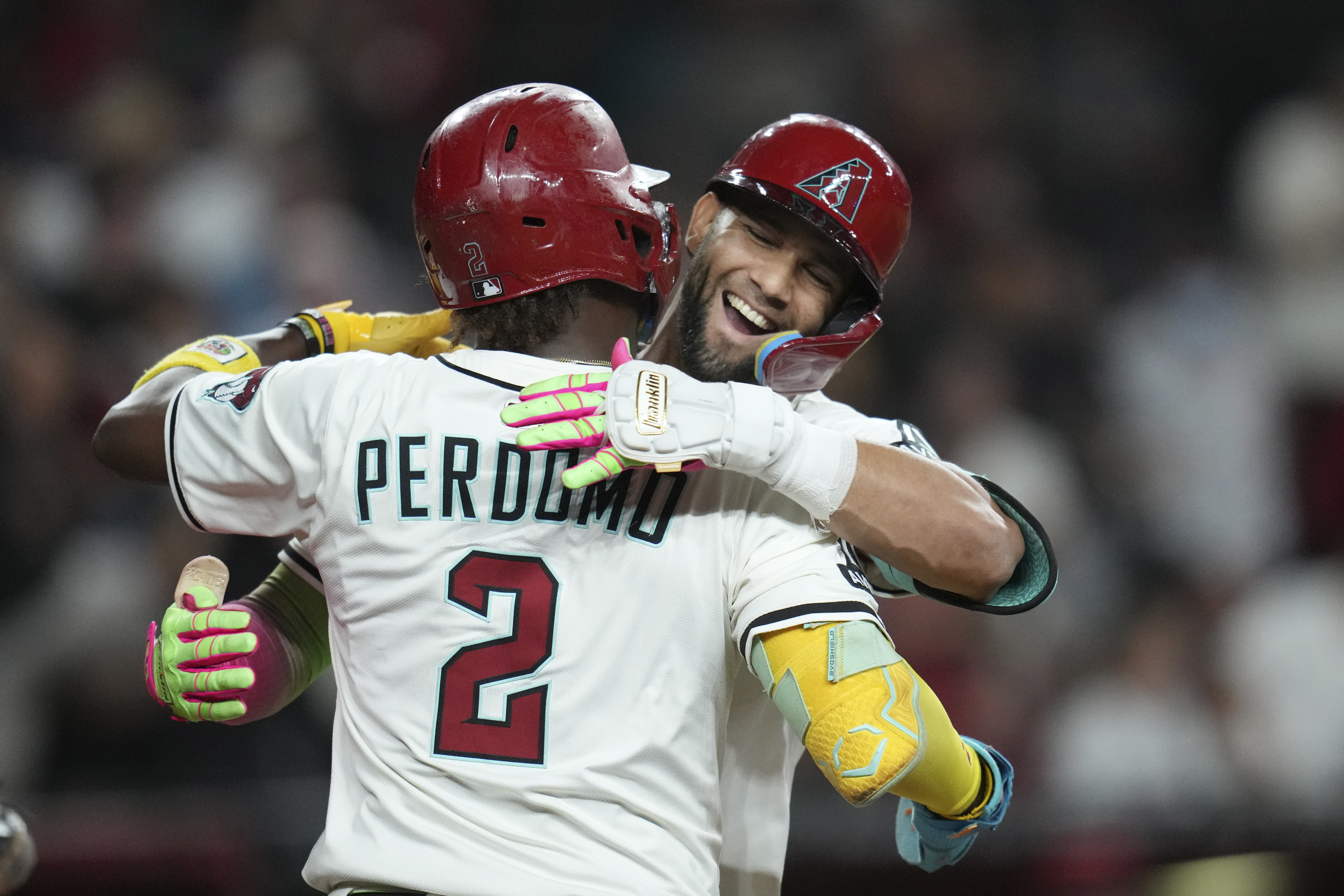 Arizona Diamondbacks' Lourdes Gurriel Jr., right, celebrates his two-run home run against the San Diego Padres with Diamondbacks' Geraldo Perdomo (2) during the eighth inning of a baseball game Tuesday, Aug. 5, 2025, in Phoenix.