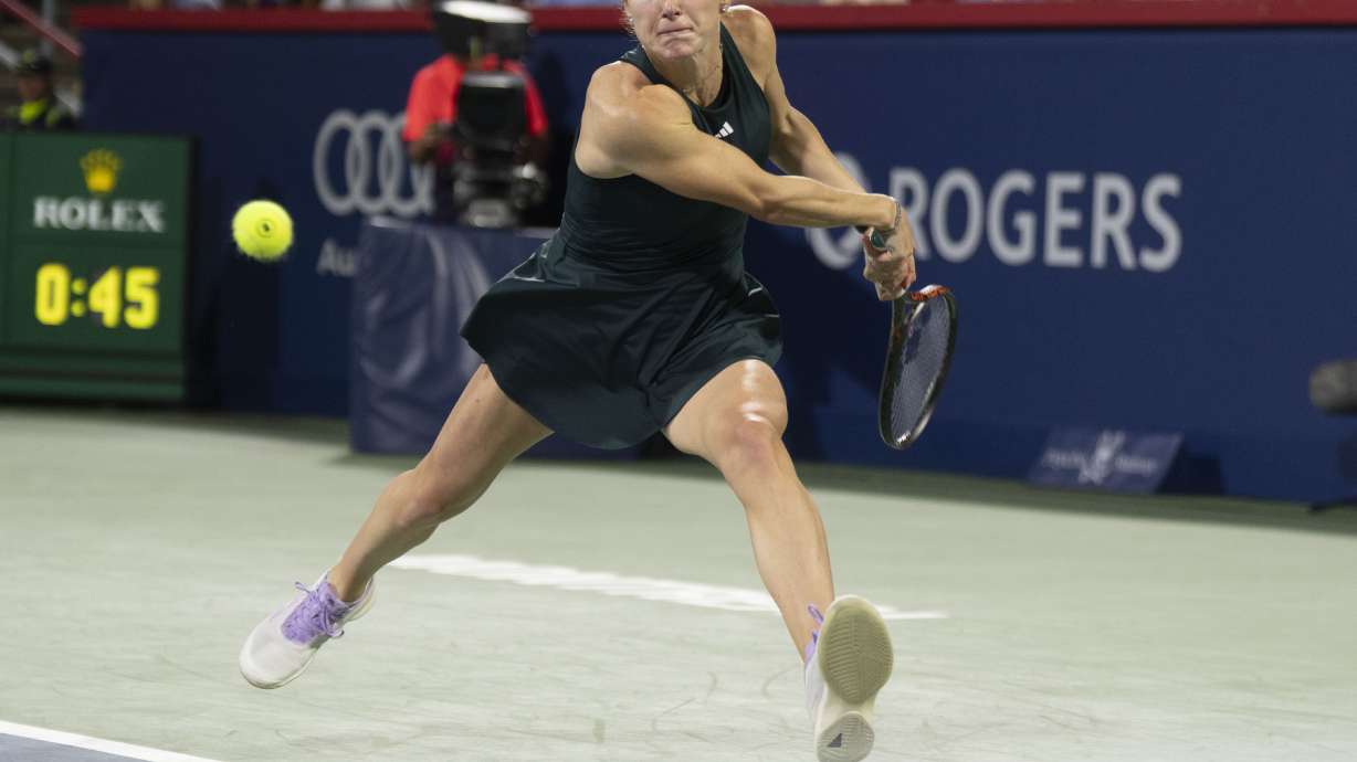 Elina Svitolina, of Ukraine, hits a return to Naomi Osaka, of Japan, during quarterfinal tennis action at the National Bank Open in Montreal, Tuesday, Aug. 5, 2025.