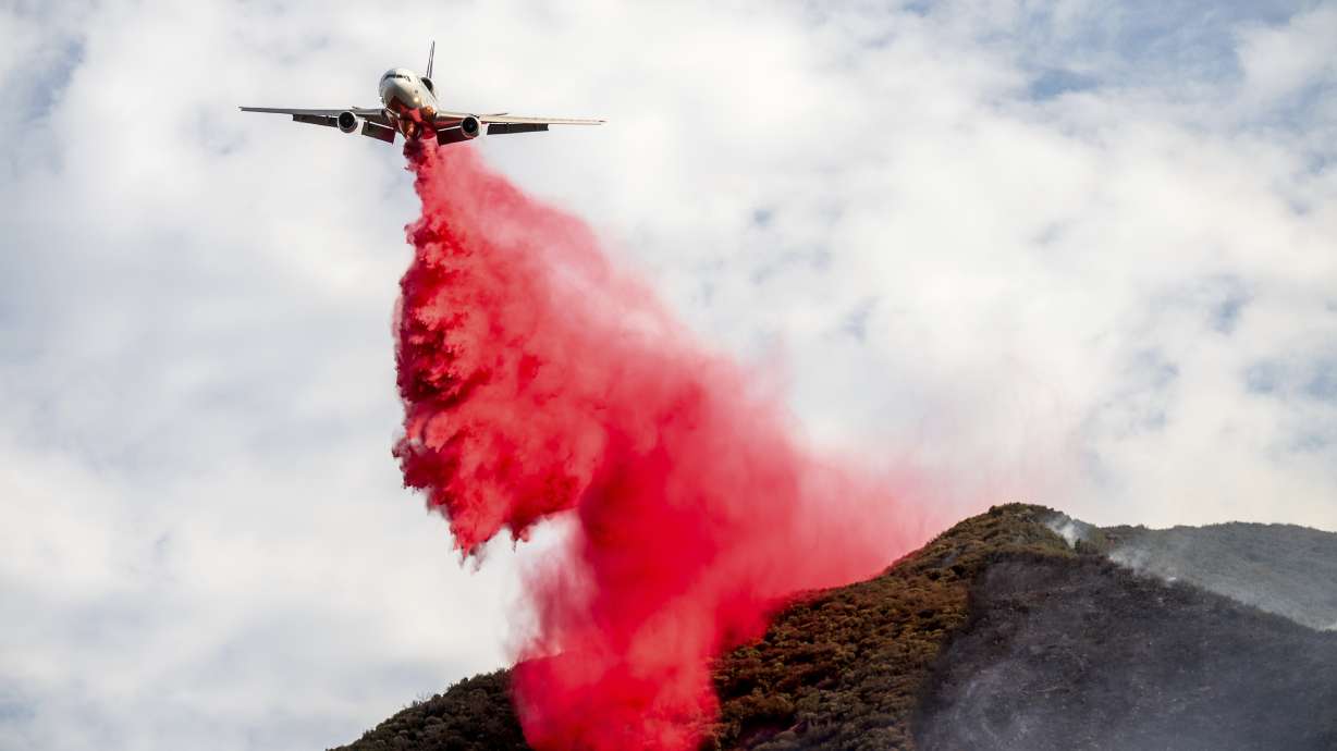 An air tanker drops retardant on the Gifford Fire burning on Monday, in Los Padres National Forest, Calif.