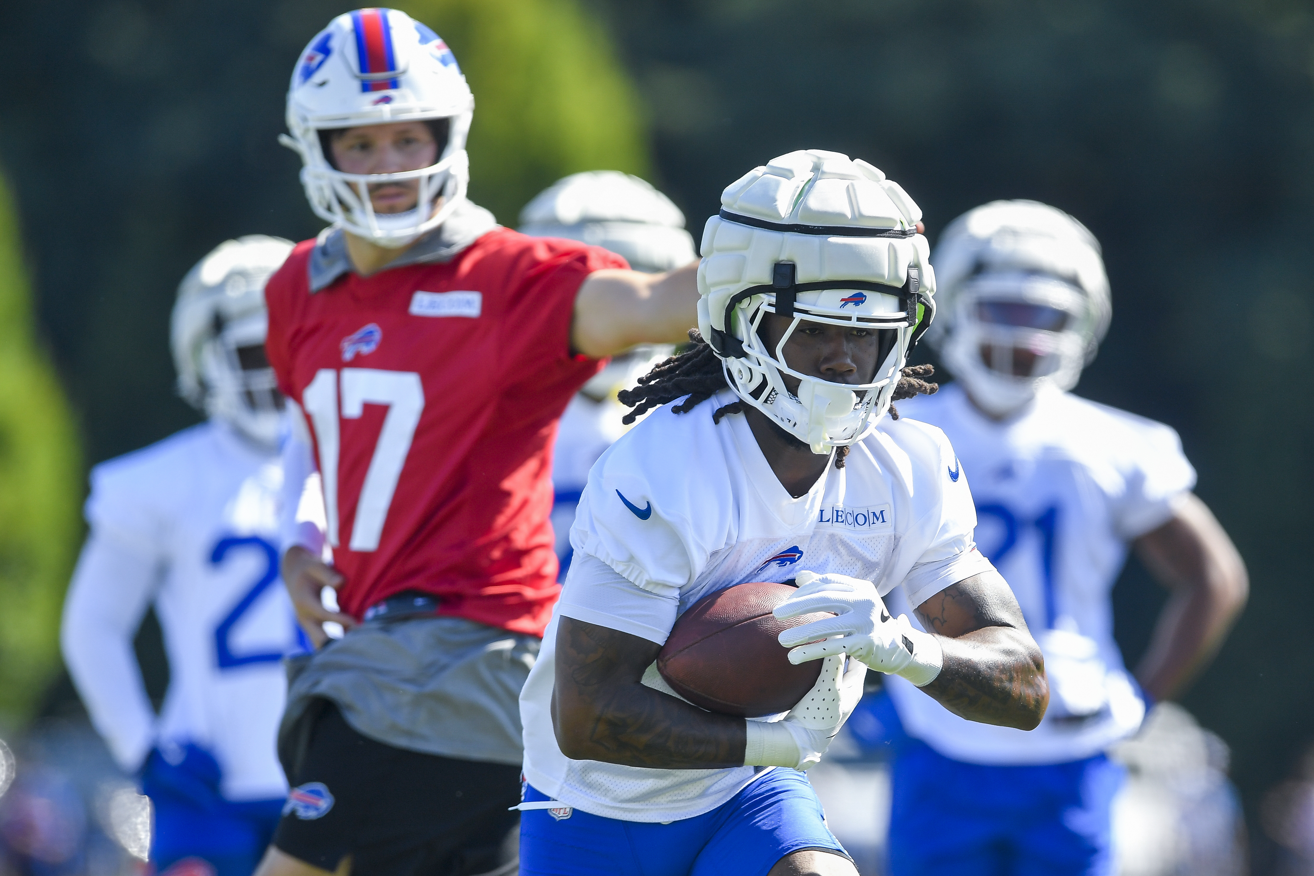 Buffalo Bills running back James Cook (4) takes a handoff from quarterback Josh Allen (17) during practice at the team’s NFL football training camp, Wednesday, July 23, 2025, in Pittsford, N.Y.