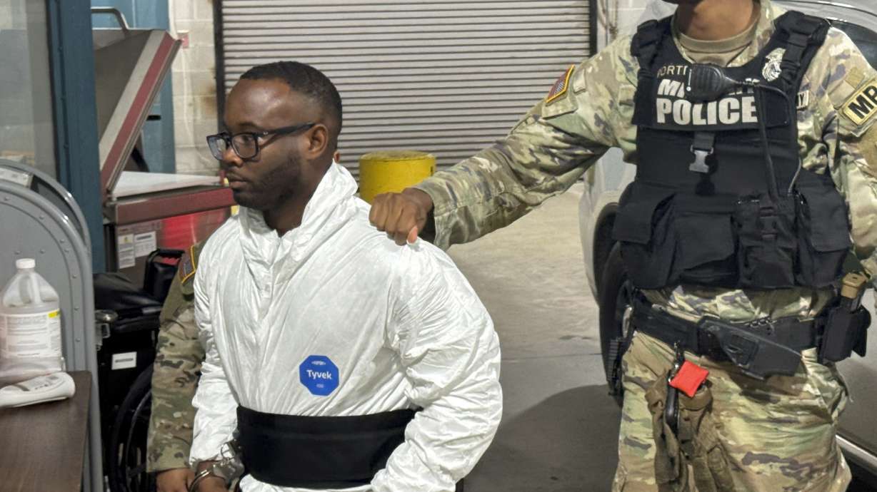 Sgt. Quornelius Radford, a suspect in the shooting of five soldiers at Fort Stewart, is escorted by military police into a booking room at the Liberty County Jail in Hinesville, Ga., Wednesday.