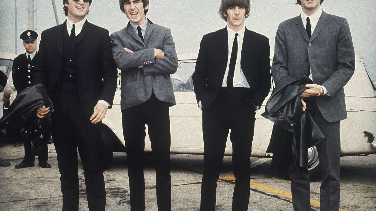 FILE - The Beatles, from left, John Lennon, George Harrison, Ringo Starr and Paul McCartney arrive in Liverpool, England on July 10, 1964, for the premiere of their movie "A Hard Day's Night."