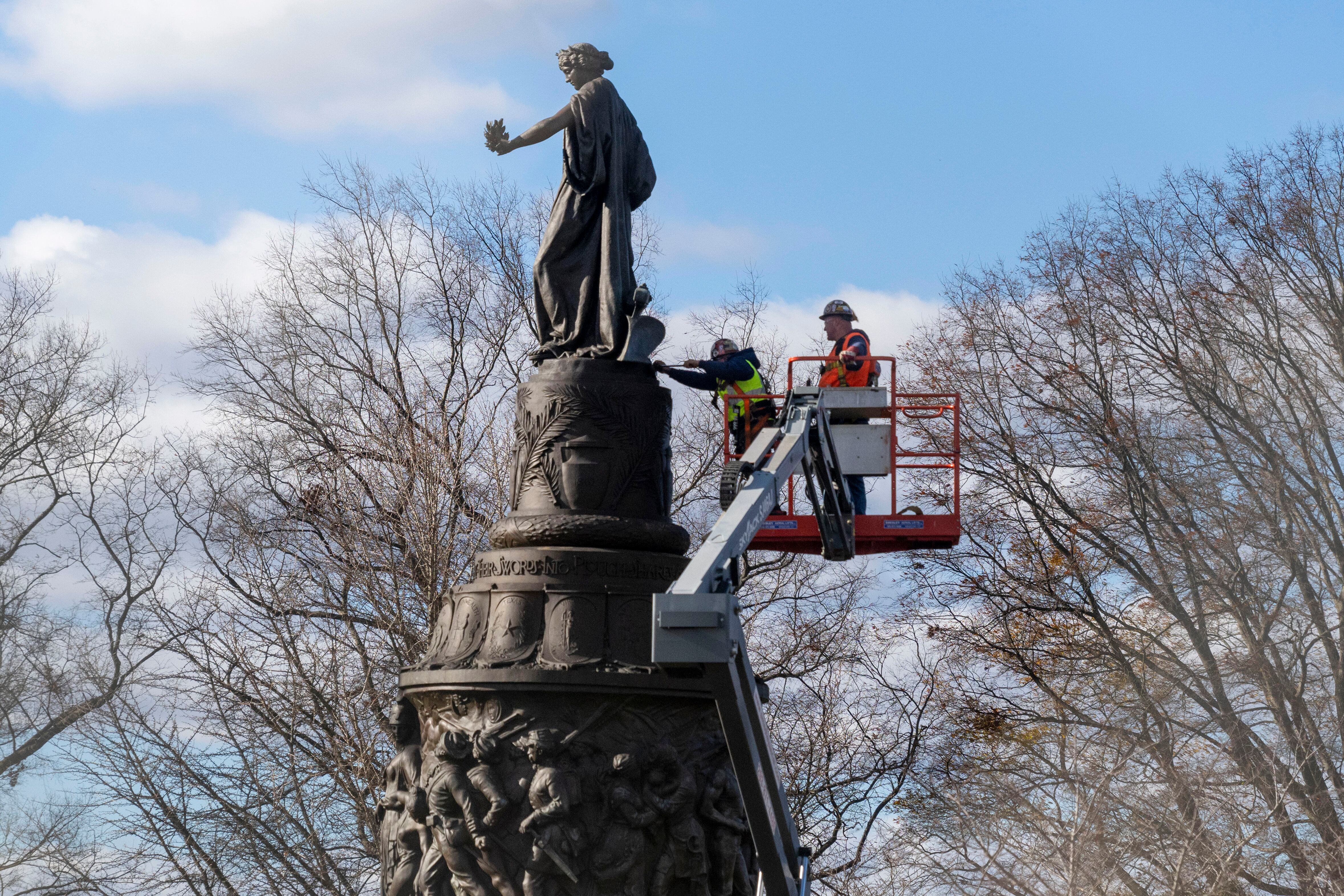 Workers prepare a Confederate Memorial for removal in Arlington National Cemetery, Dec. 18, 2023, in Arlington, Va. The Confederate memorial was removed in 2023, but the Trump administration is returning it.