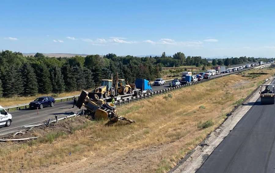 A backhoe lies inside the median after the semitruck hauling it hit the Porterville Road Bridge in Idaho, Tuesday. Tabitha Farley, a driver for MVP Rentals, was behind the semi when it hit the bridge.