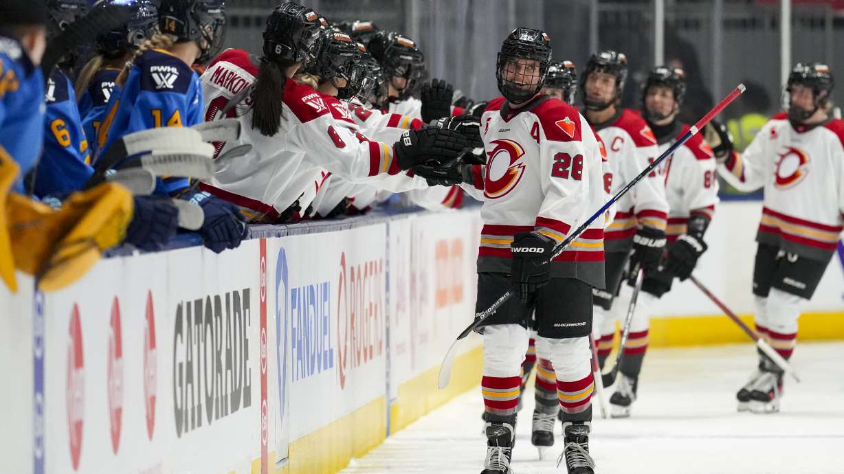 FILE - Ottawa Charge forward Emily Clark (26) is congratulated by her teammates after scoring a goal against the Toronto Sceptres during second period PWHL hockey action in Toronto, Feb. 1, 2025.