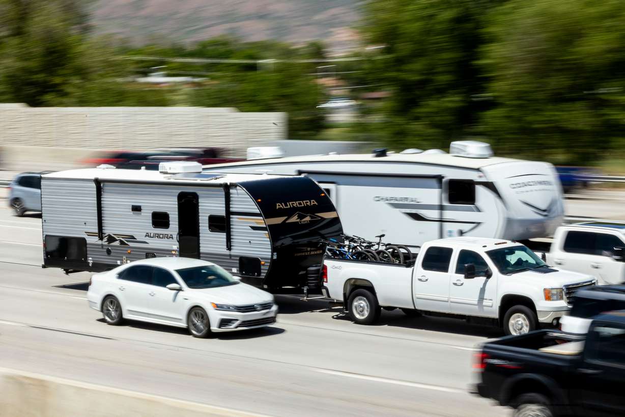 Trucks towing travel trailers drive southbound on I-15 in Lehi on May 23.