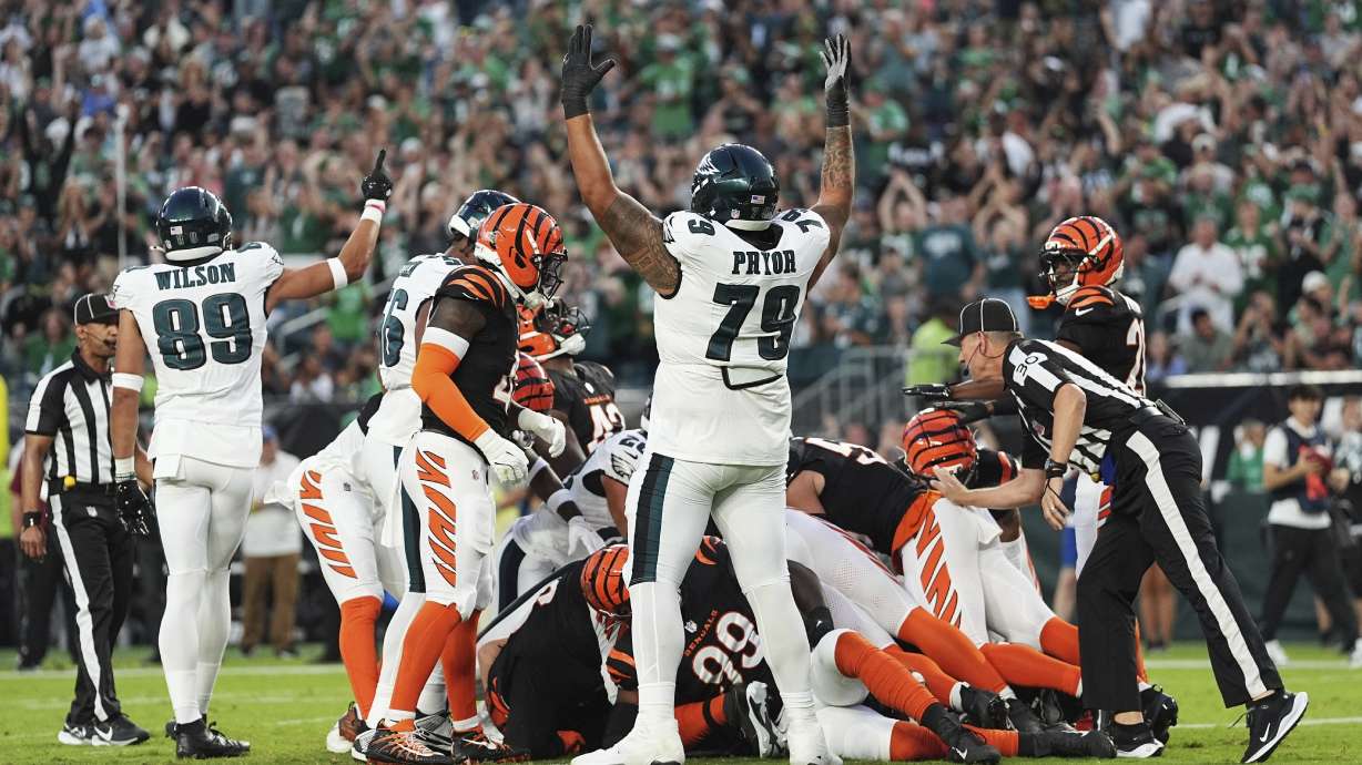 Philadelphia Eagles wide receiver Johnny Wilson (89) and Eagles offensive tackle Matt Pryor (79) celebrate a touchdown by teammate quarterback Tanner McKee (16) during the first half of an NFL preseason football game against the Cincinnati Bengals Thursday, Aug. 7, 2025, in Philadelphia.
