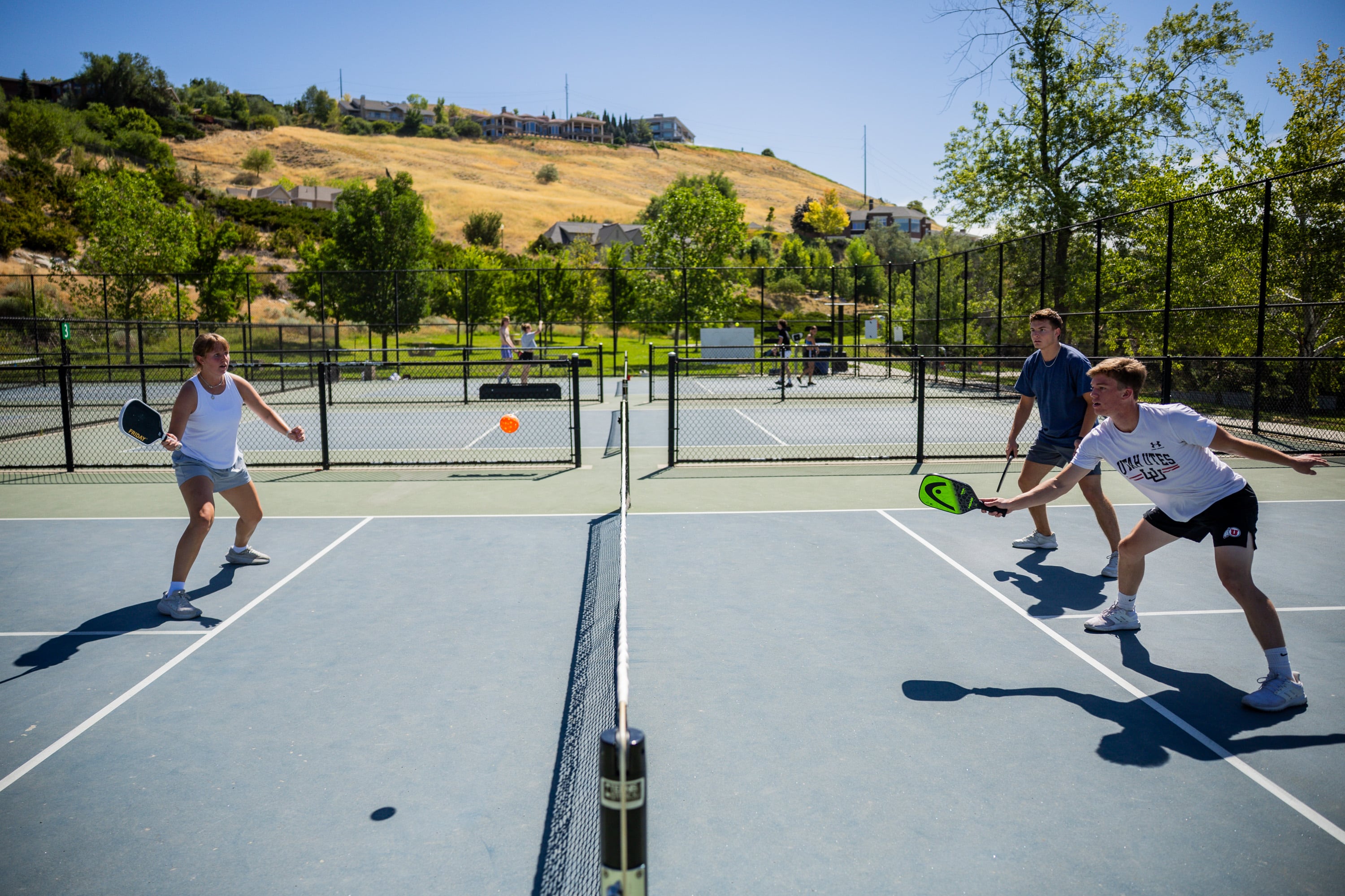 Lydia Pehrson, Cade Gillen and Josh Smith play pickleball in Salt Lake City on Thursday. Friday is National Pickleball Day, and Utah is one of the states most obsessed with the sport.