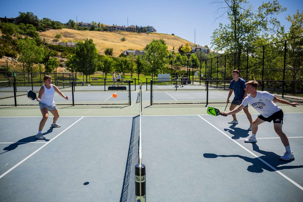 Lydia Pehrson, Cade Gillen and Josh Smith play pickleball in Salt Lake City on Thursday. Friday is National Pickleball Day, and Utah is one of the states most obsessed with the sport.