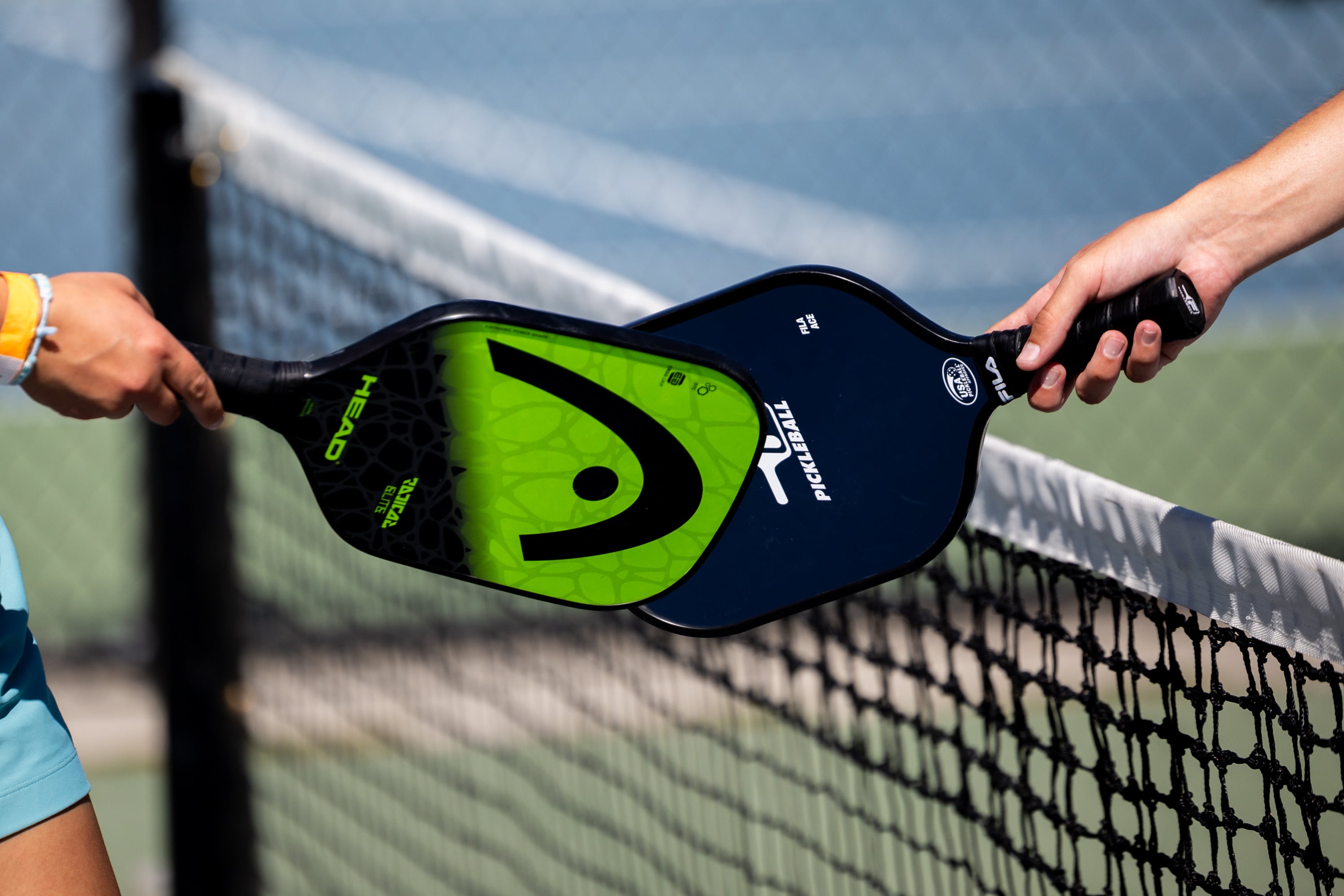 Players tap rackets at the end of a pickleball match in Salt Lake City on Thursday. Utah's pickleball obsession mainly comes from its social nature.
