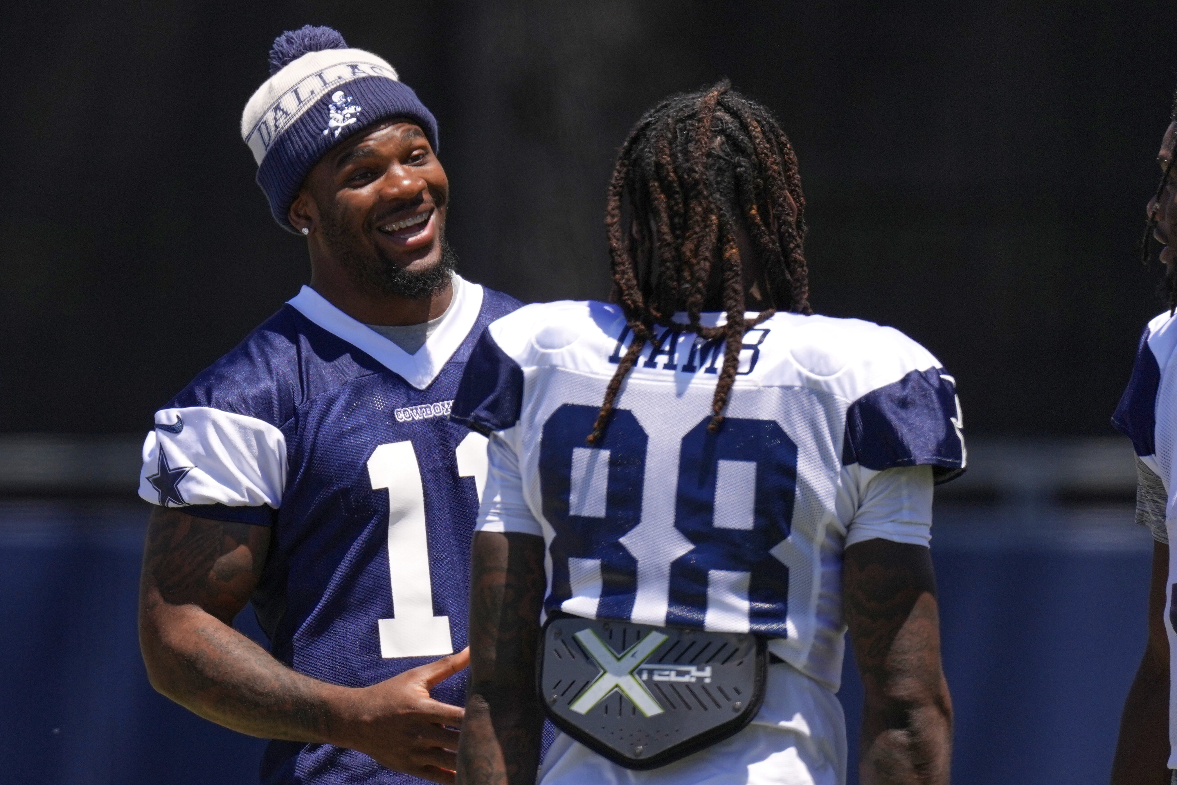 Dallas Cowboys defensive end Micah Parsons, left, talks with wide receiver CeeDee Lamb during training camp Thursday, July 31, 2025, in Oxnard, Calif.