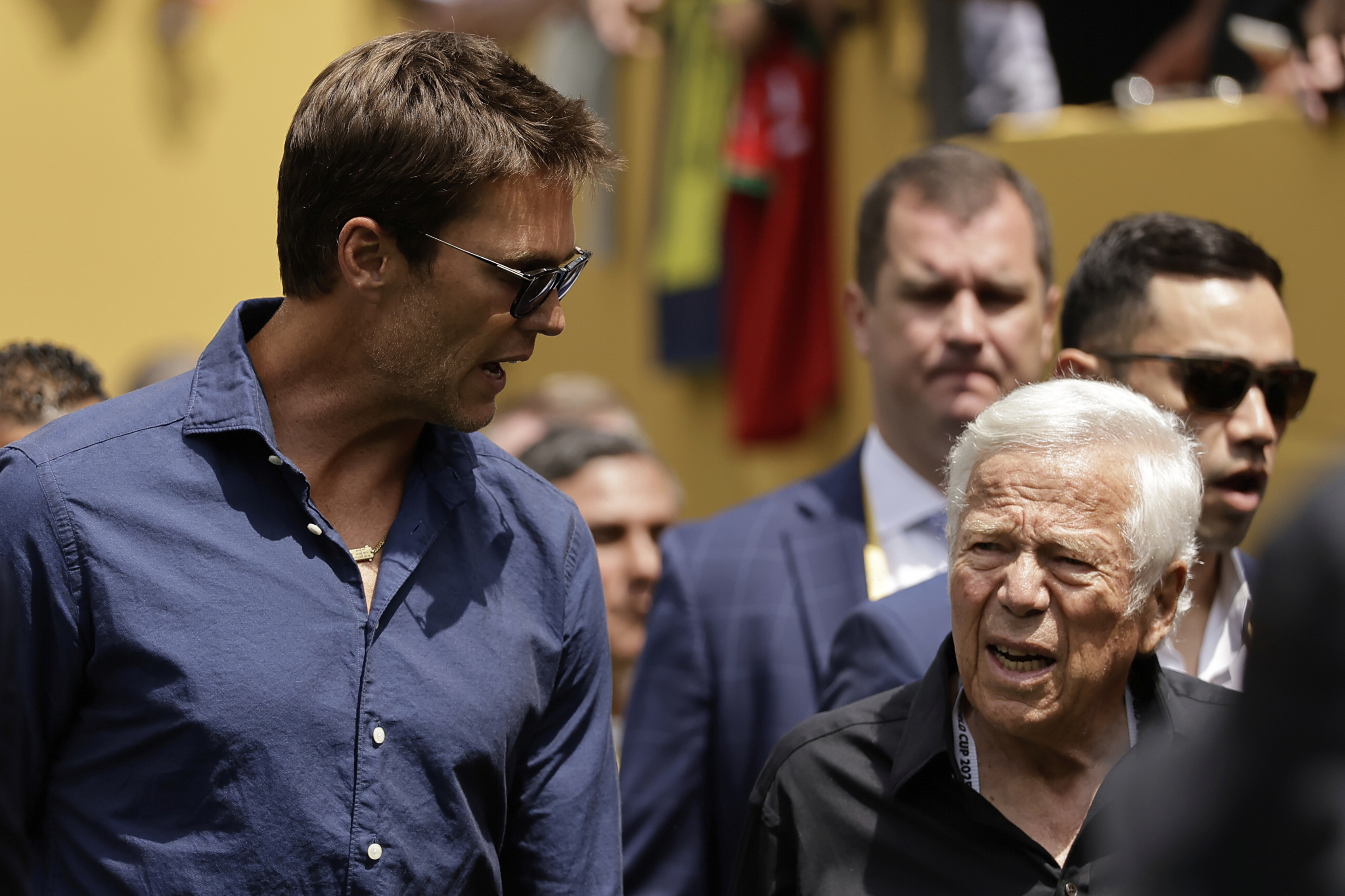 Former New England Patriots quarterback Tom Brady, left, and New England Patriots owner Robert Kraft walk on the field before the Club World Cup final soccer match between Chelsea and PSG in East Rutherford, N.J., Sunday, July 13, 2025.