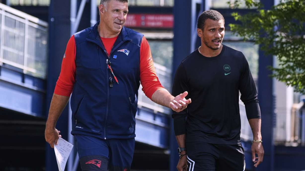 New England Patriots head coach Mike Vrabel, left, chats with Boston Celtics head coach Joe Mazzulla at the football team's NFL training camp, Wednesday, July 30, 2025, in Foxborough, Mass.