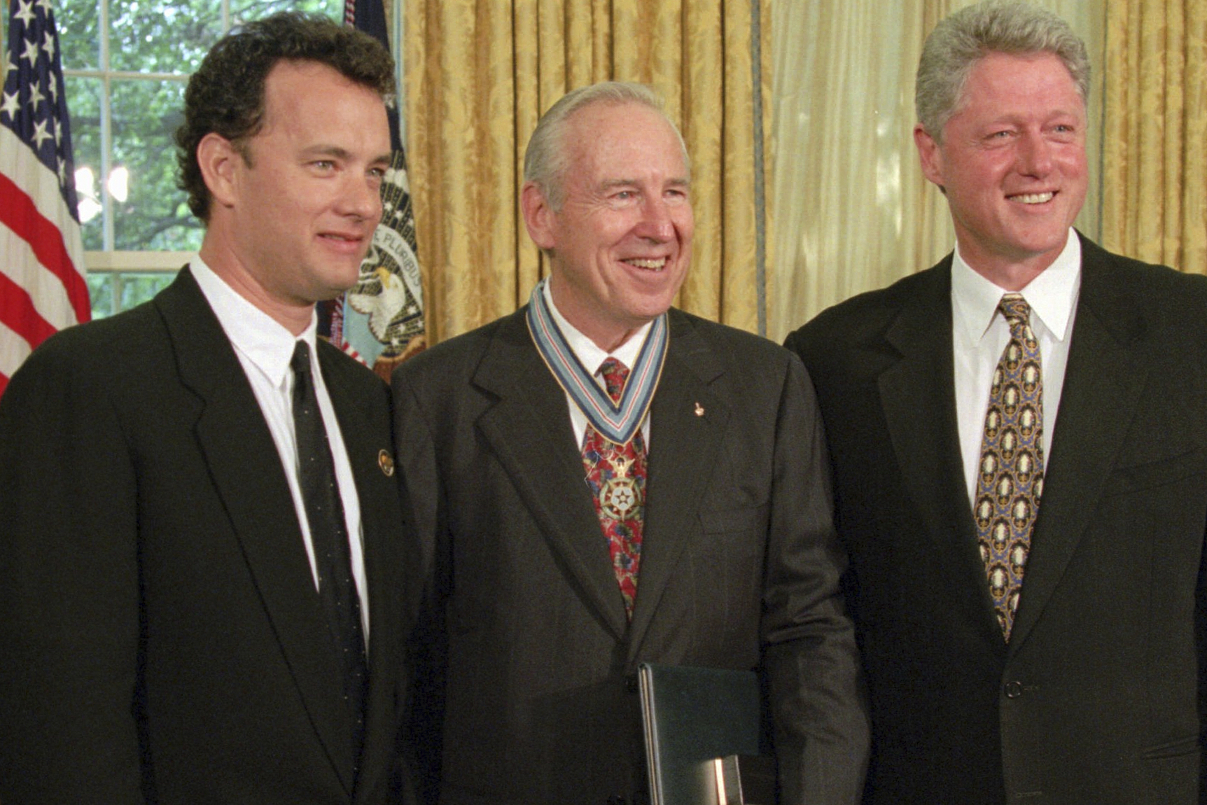 President Bill Clinton with actor Tom Hanks and former astronaut James Lovell in the Oval Office, July 26, 1995, after presenting Lovell with the Congressional Space Medal of Honor. Hanks portrayed Lovell, who died Friday at age 97, in the movie "Apollo 13."