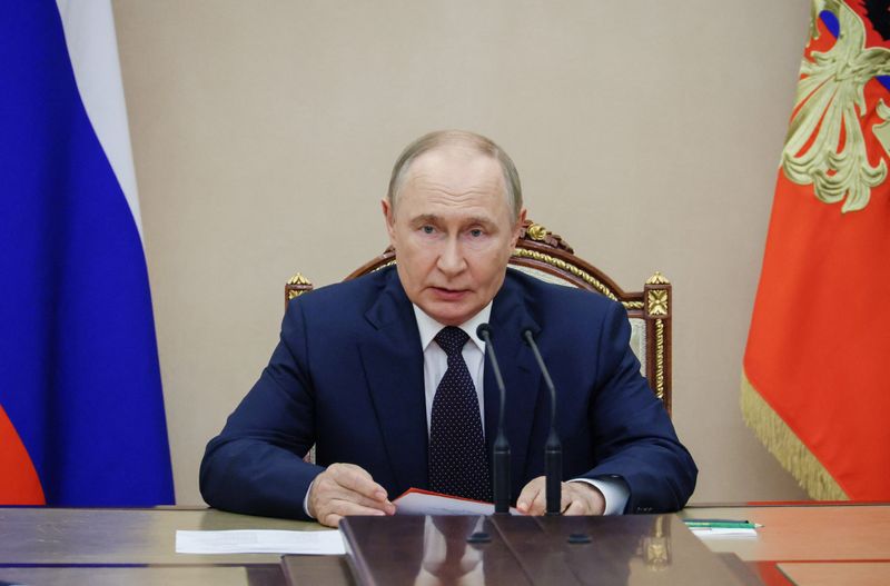 Russian President Vladimir Putin chairs a meeting with members of the Security Council in Moscow, Russia, Friday.