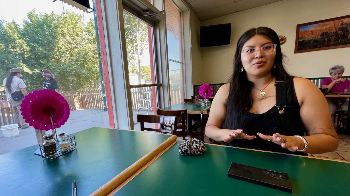 Alexandra Leal discusses her concerns with the proposal to bring a Major League Baseball team to Salt Lake City's west side at El Asadero, an area restaurant, on Aug. 2.