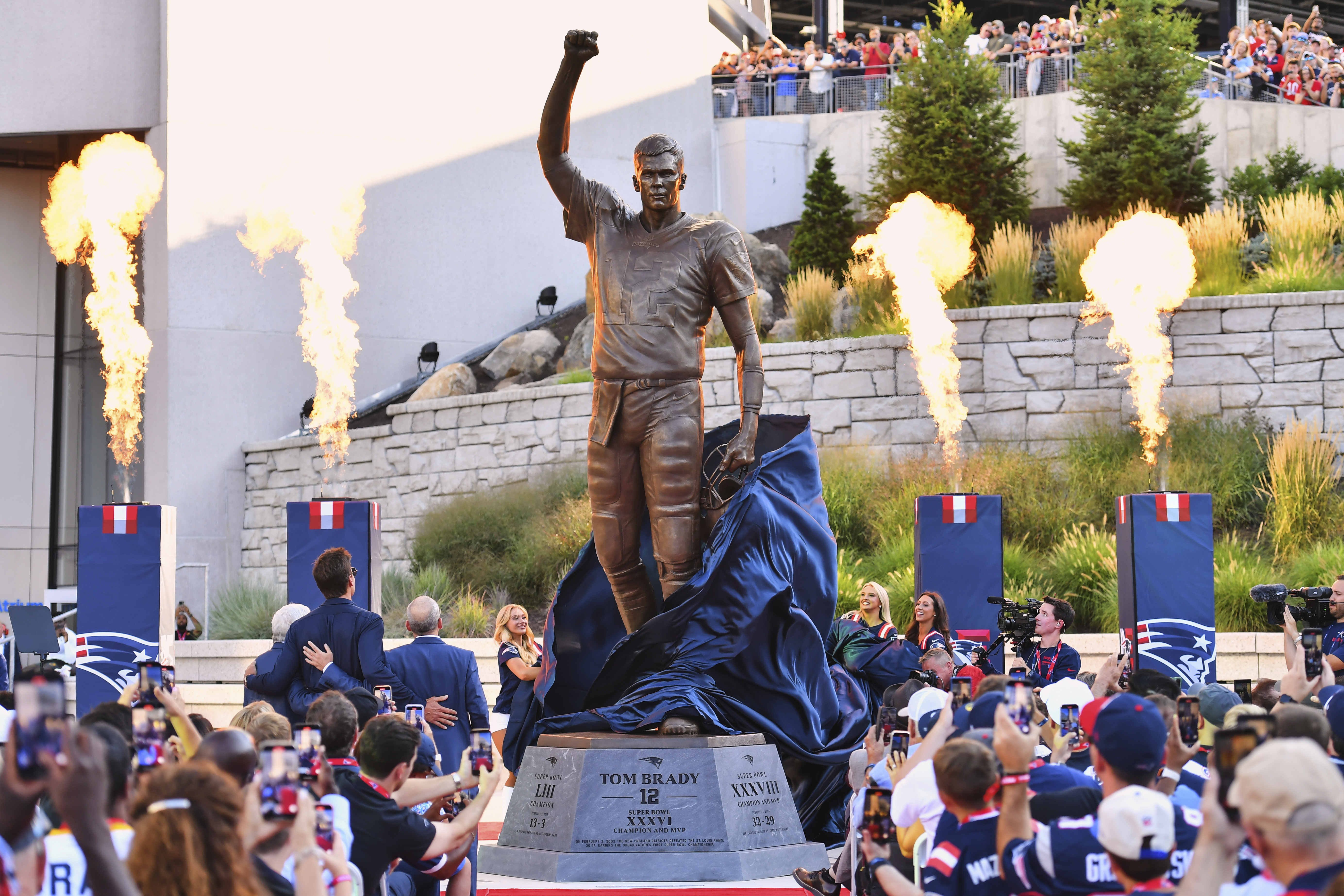 A bronze statue of former New England Patriots quarterback Tom Brady is unveiled in Patriot Place Plaza before an NFL preseason football game between the Washington Commanders and the New England Patriots Friday, Aug. 8, 2025, in Foxborough, Mass.