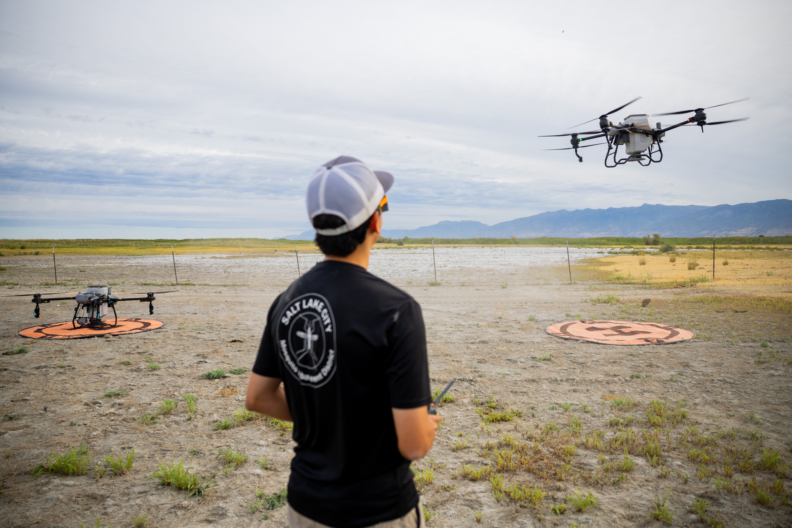 Sam Wilson operates a drone to spray Natular G30 over the wetland habitats near the Salt Lake City International Airport on Friday. The drones are part of an amped up effort to combat mosquitoes and the diseases they spread.