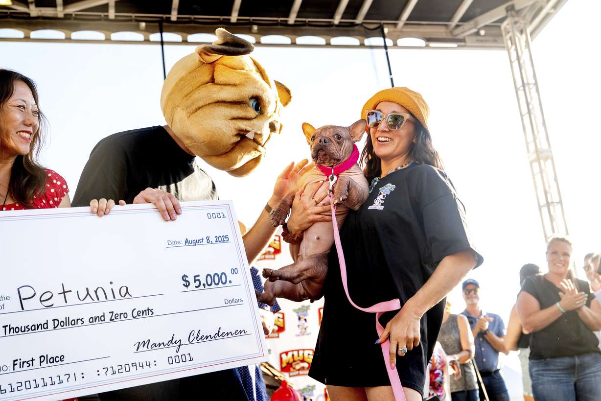 Petunia and owner Shannon Nyman, right, celebrate winning first place in the World's Ugliest Dog Contest at the Sonoma County Fair in Santa Rosa, Calif., on Friday.