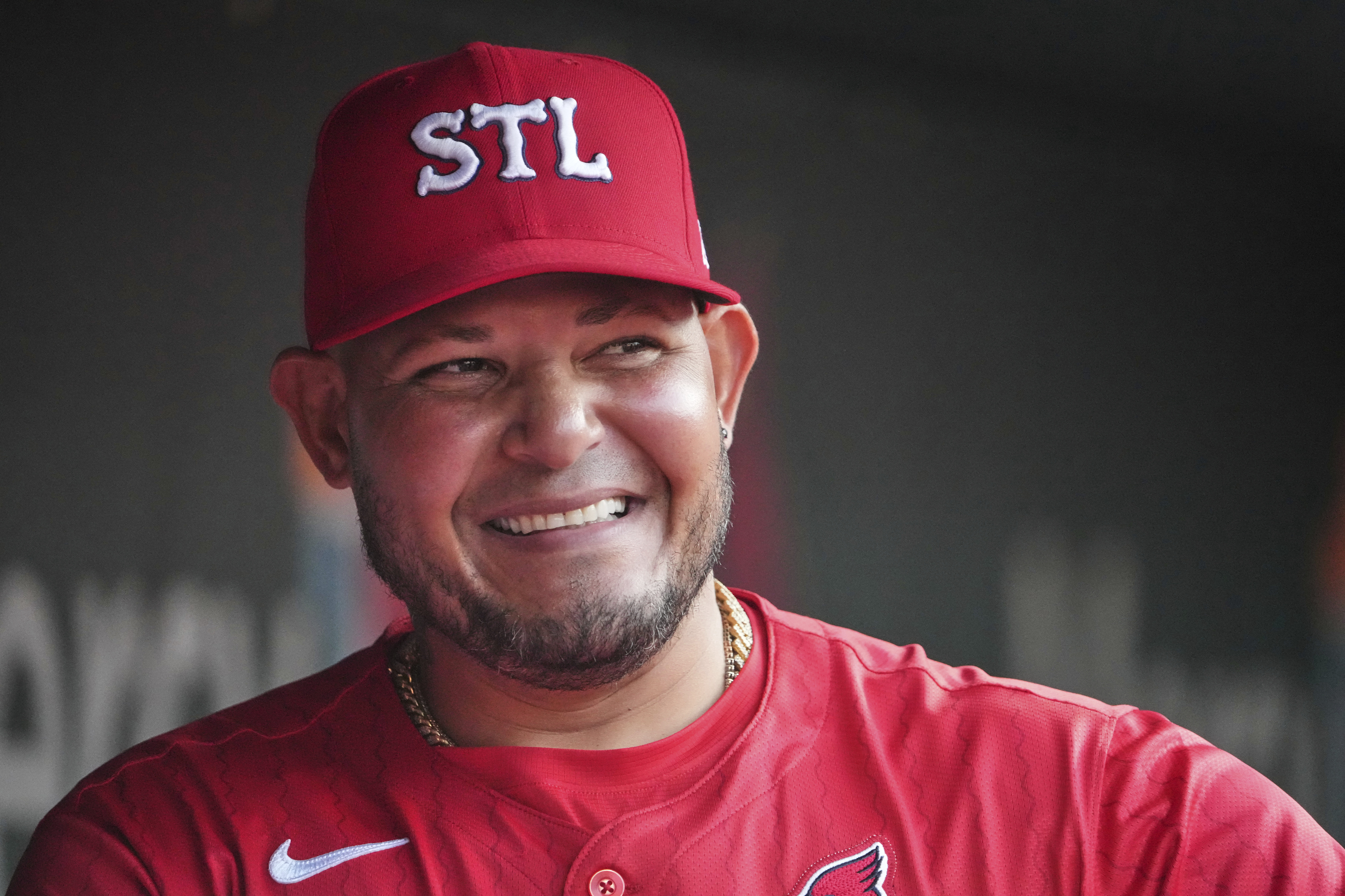 St. Louis Cardinals guest coach Yadier Molina is seen in the dugout before the start of a baseball game against the Chicago Cubs Friday, Aug. 8, 2025, in St. Louis.