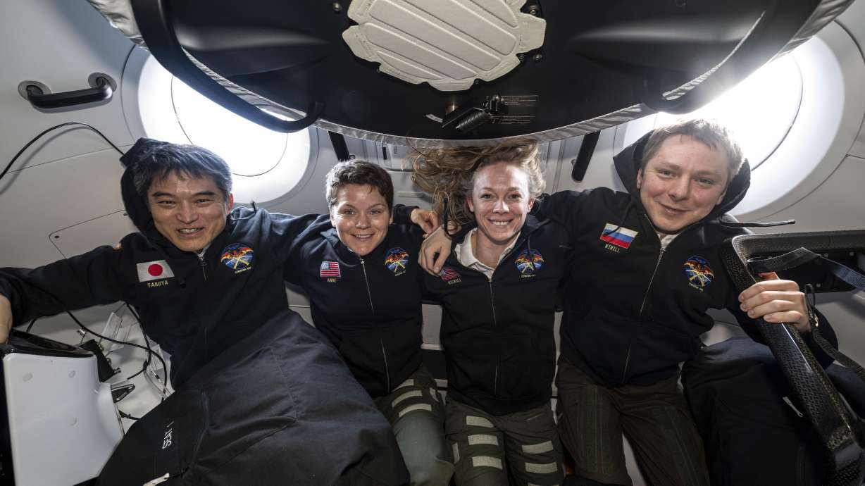NASA's SpaceX Crew-10 members Takuya Onishi, Anne McClain, Nichole Ayers and Kirill Peskov pose inside the SpaceX Dragon that carried them to the International Space Station and will return to Earth.