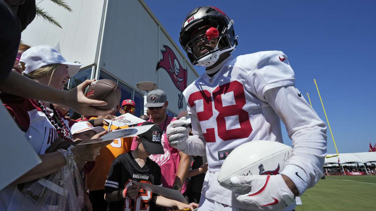 Tampa Bay Buccaneers safety Shilo Sanders signs autographs for fans during Back Together Weekend at an NFL football training camp practice Sunday, July 27, 2025, in Tampa, Fla.
