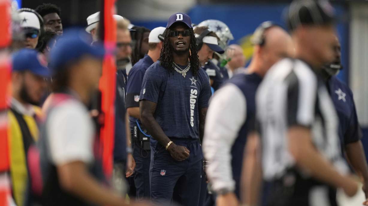 Dallas Cowboys wide receiver CeeDee Lamb, center, stands on the sidelines during the first half of an NFL preseason football game against the Los Angeles Rams, Saturday, Aug. 9, 2025, in Inglewood, Calif.