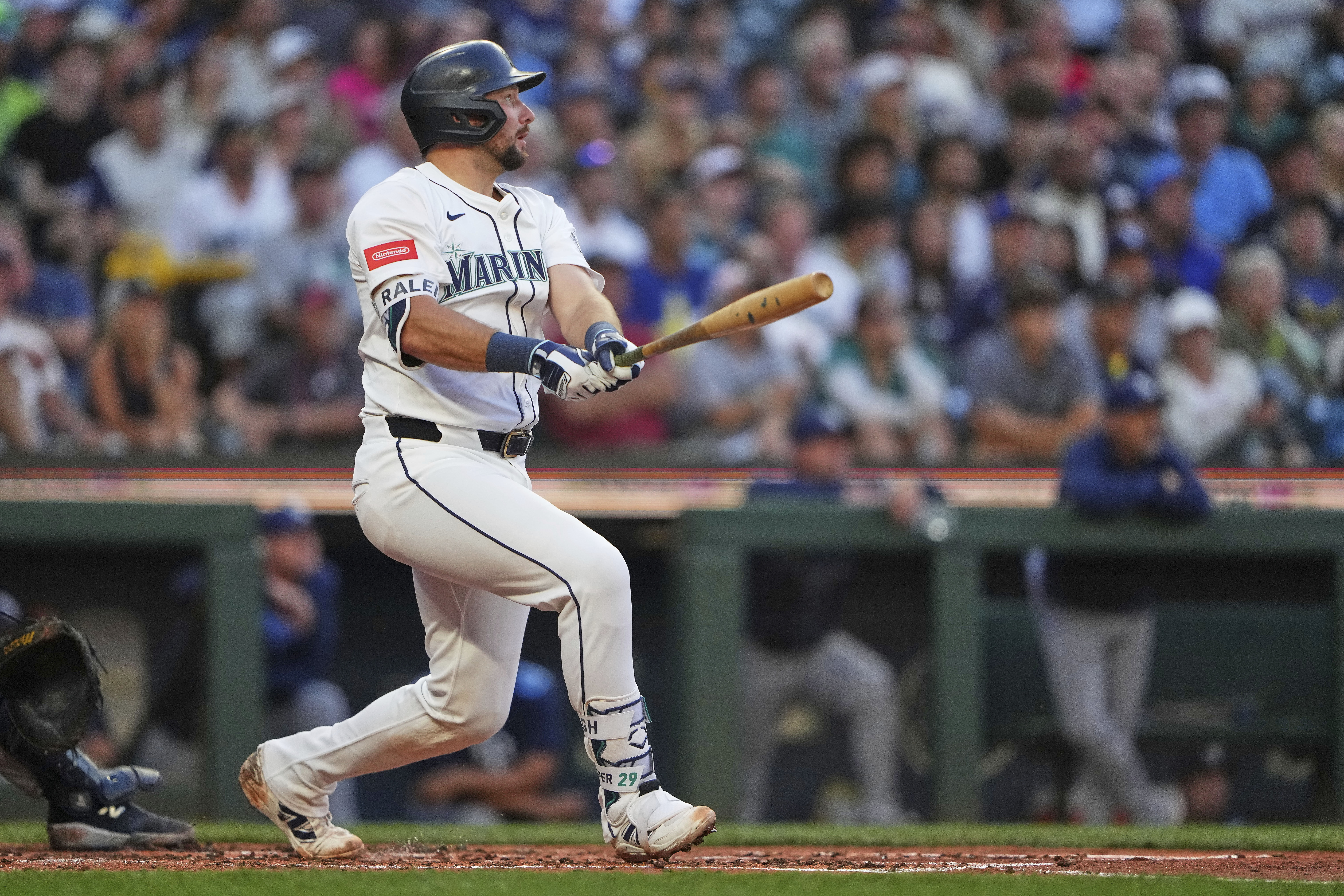 Seattle Mariners' Cal Raleigh follows through on a three-run home run against the Tampa Bay Rays during the third inning of a baseball game Saturday, Aug. 9, 2025, in Seattle.