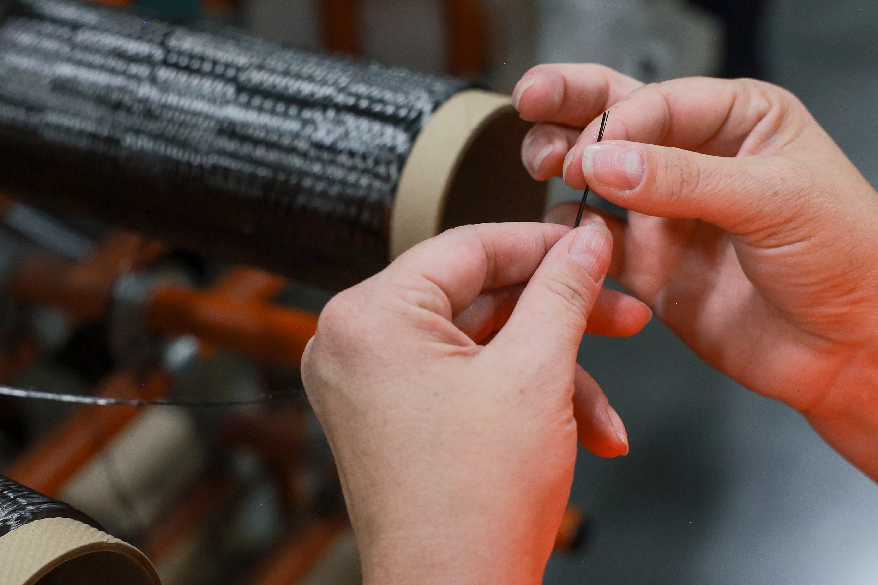Rep. Celeste Maloy looks at a strand of carbon fiber during a tour of Hexcel’s facilities in West Valley City on Friday.