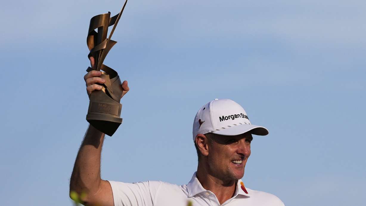 Justin Rose, of England, holds the trophy after winning the St. Jude Championship golf tournament Sunday, Aug. 10, 2025, in Memphis, Tenn.