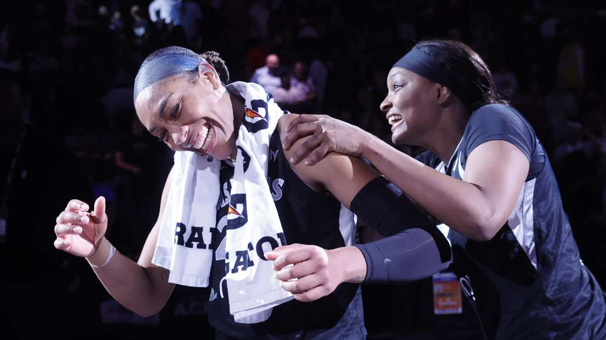 Las Vegas Aces center A'ja Wilson, left, and forward NaLyssa Smith, right, celebrate after their team defeated the Connecticut Sun in a WNBA basketball game Sunday, Aug. 10, 2025, in Las Vegas.