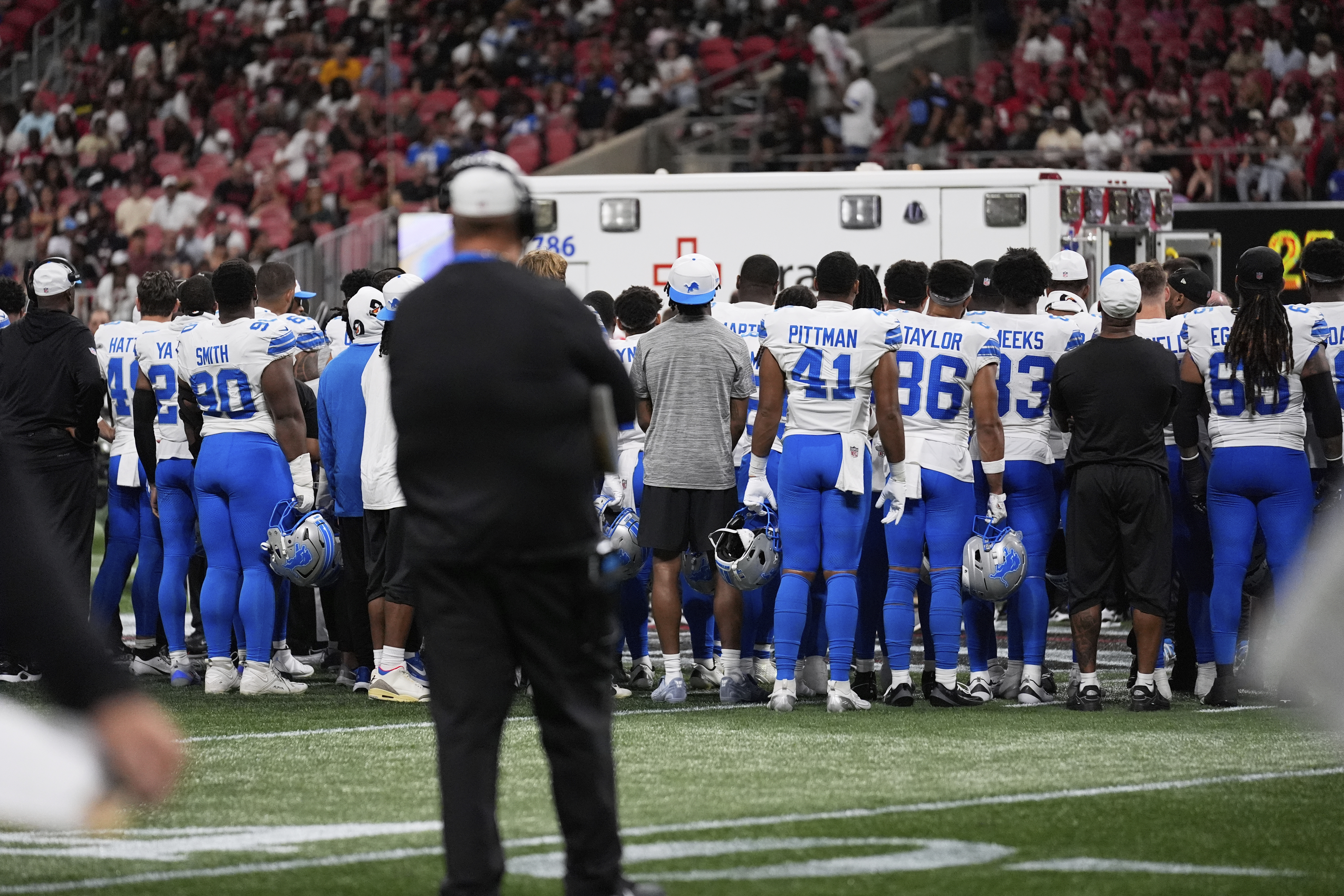 Detroit Lions players stand on the field after safety Morice Norris was injured during the second half of an NFL preseason football game against the Atlanta Falcons Friday, Aug. 8, 2025, in Atlanta.