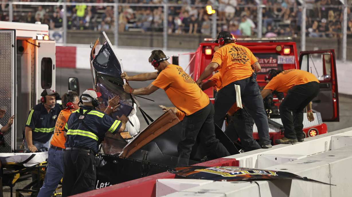 Track crew members rip the roof off of Robbie Brewer's car to remove him after a medical emergency in the first 20-lap Sportsman Series race at Bowman Gray Stadium, Saturday, Aug. 9, 2025, in Winston-Salem, N.C.