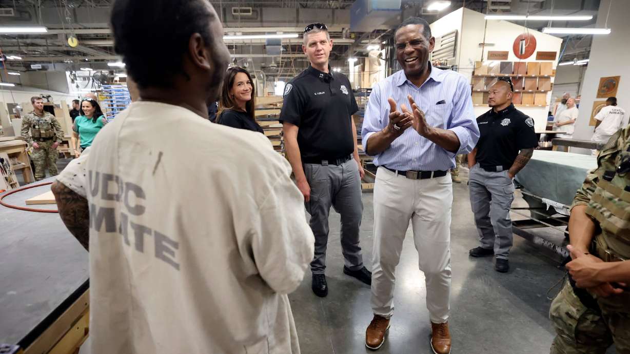 Rep. Burgess Owens, R-Utah, talks with an inmate working in the Utah Correctional Industries building while Owens tours the Utah State Correctional Facility in Salt Lake City, Aug. 4.
