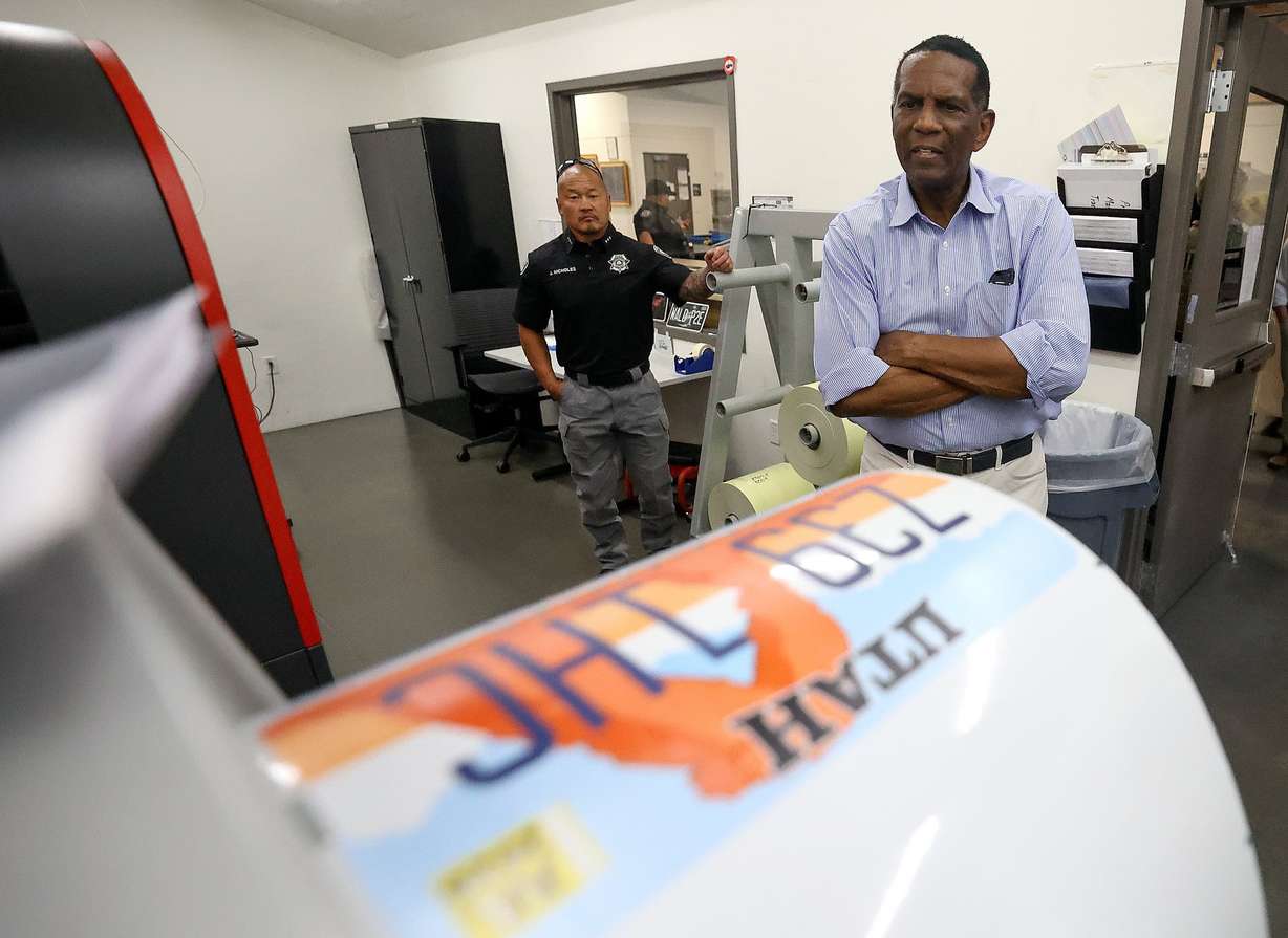 Rep. Burgess Owens, R-Utah, looks at a roll of recently printed license plates, made by Utah State Correctional Facility inmates, while touring the Utah Correctional Industries building at the Utah State Correctional Facility in Salt Lake City, Aug. 4.