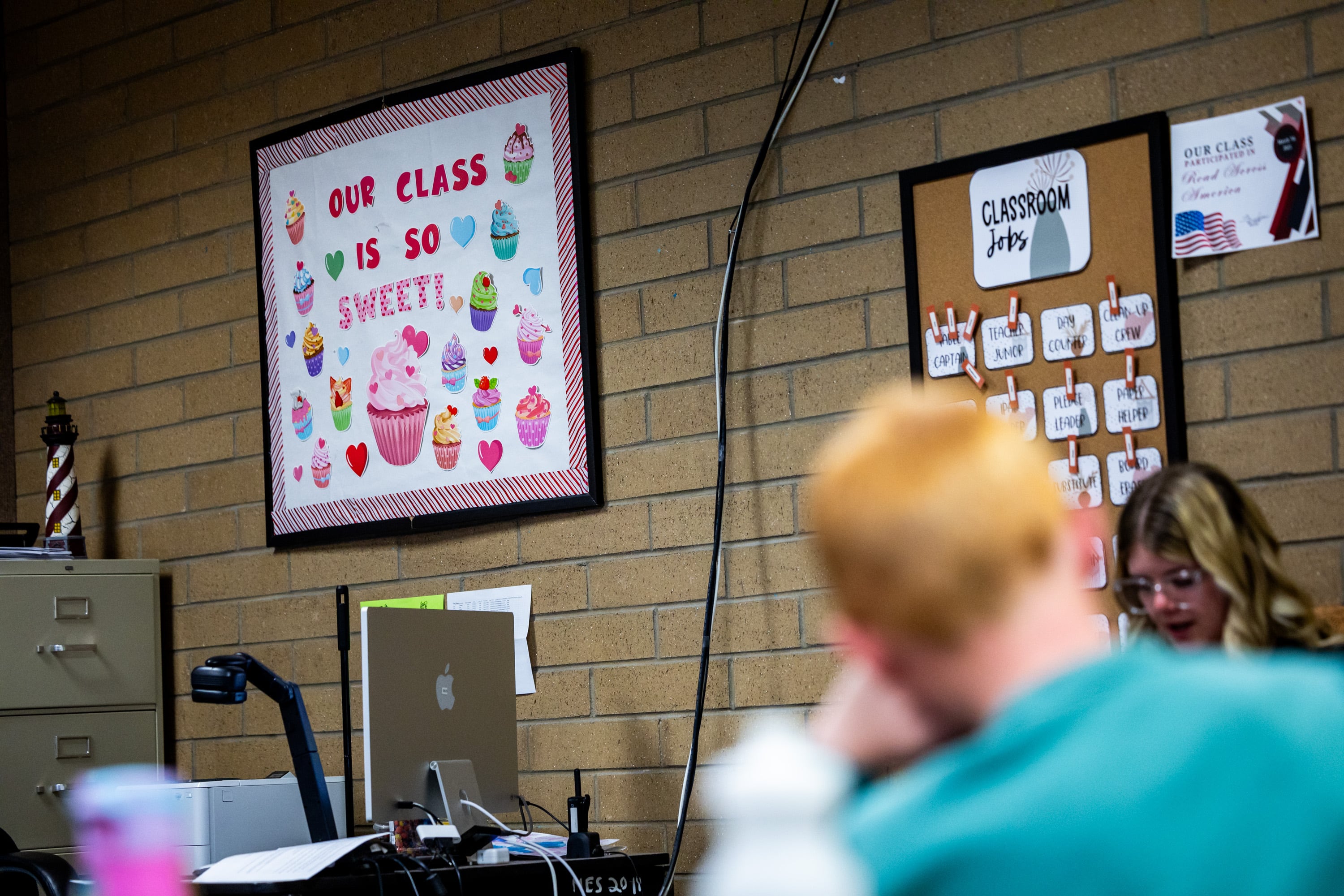 Second grade teacher Kelsey Fullmer, right, reads to students at Manti Elementary School in Manti on March 24. Chronic absenteeism in Utah has nearly doubled over the past decade.