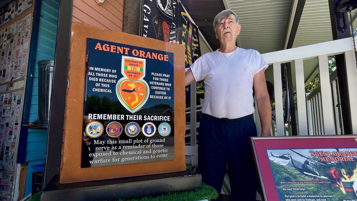 A memorial at Sunset Veterans Memorial Park to victims of Agent Orange during the Vietnam War is partially complete and should be done in a matter of weeks. The July 8, 2025, photo shows Larry Kerr, who's pushed the initiative, with a model of the memorial at his home in Syracuse.