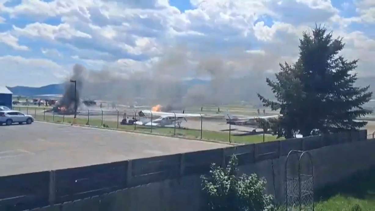 A plane crashes into a parked aircraft at Kalispell City Airport, triggering a large fire, in Kalispell, Mont., Monday.
