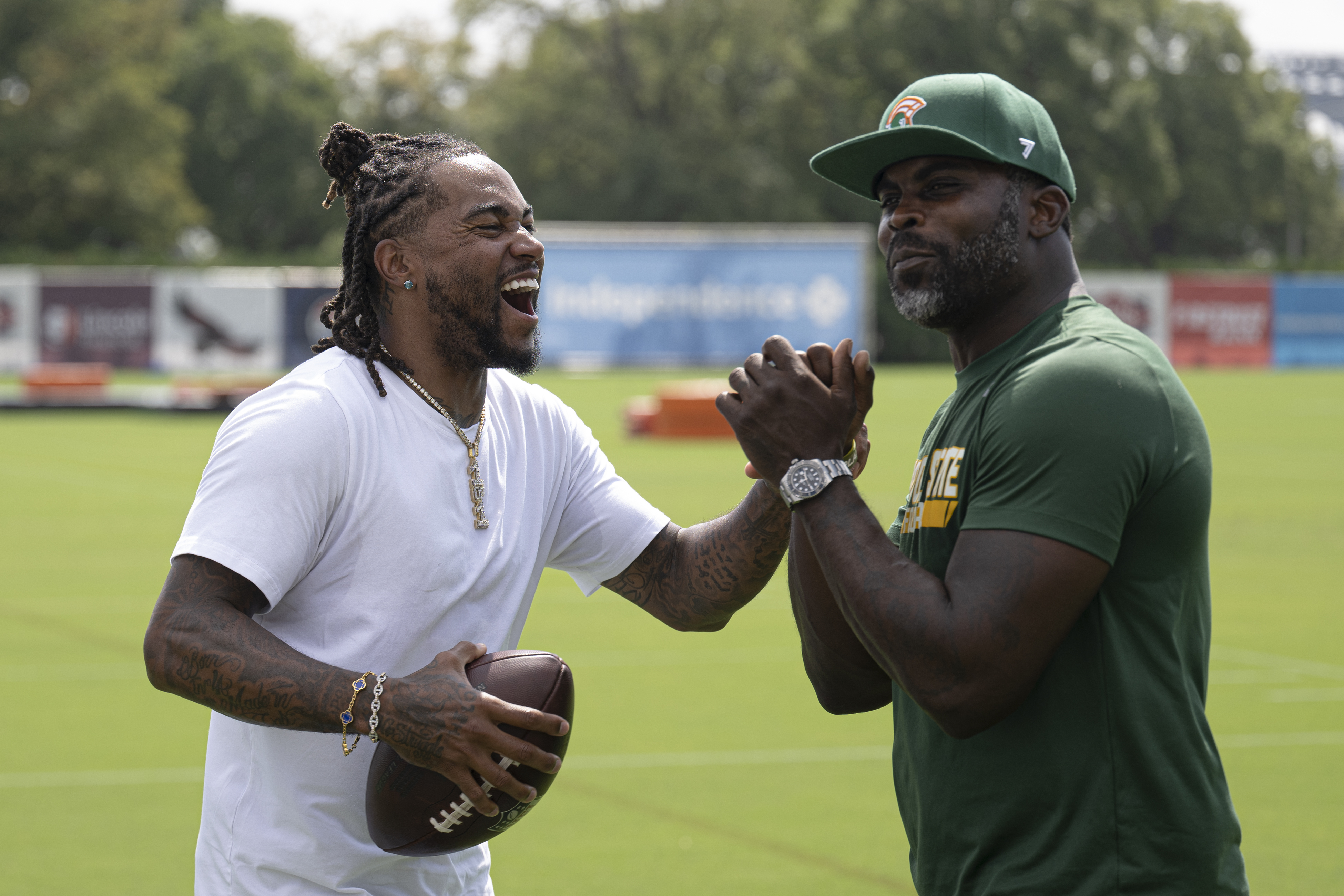 Former Philadelphia Eagles stars Michael Vick, right, and DeSean Jackson greet each other at the Eagles' NFL football training camp Tuesday, Aug. 12, 2025, in Philadelphia. Now head coaches at Norfolk State and Delaware State respectively, Vick and Jackson are set to face off in a highly anticipated matchup on Oct. 30 at Lincoln Financial Field.