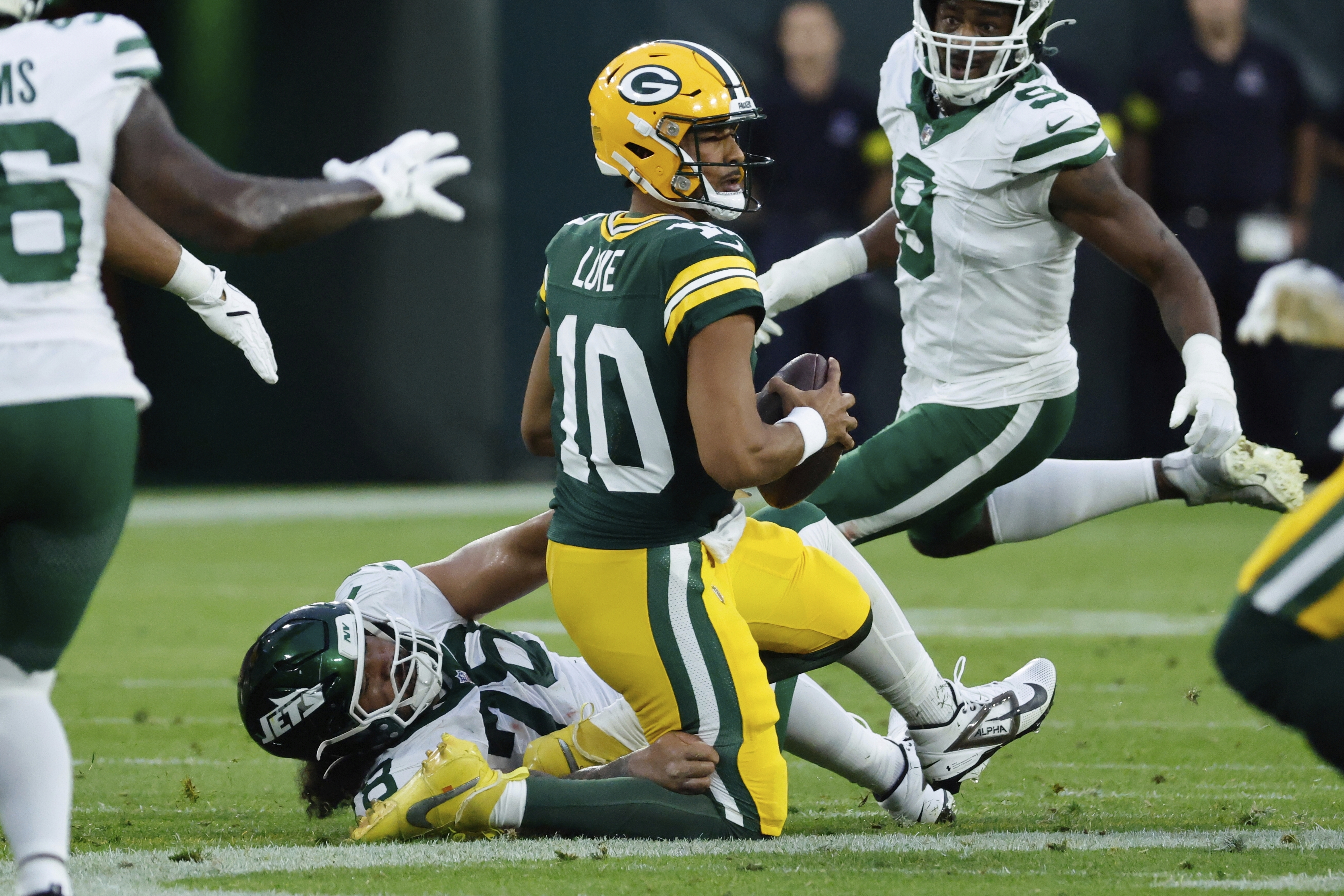 New York Jets' Jay Tufele sacks Green Bay Packers' Jordan Love during the first half of a preseason NFL football game Saturday, Aug. 9, 2025, in Green Bay, Wis.