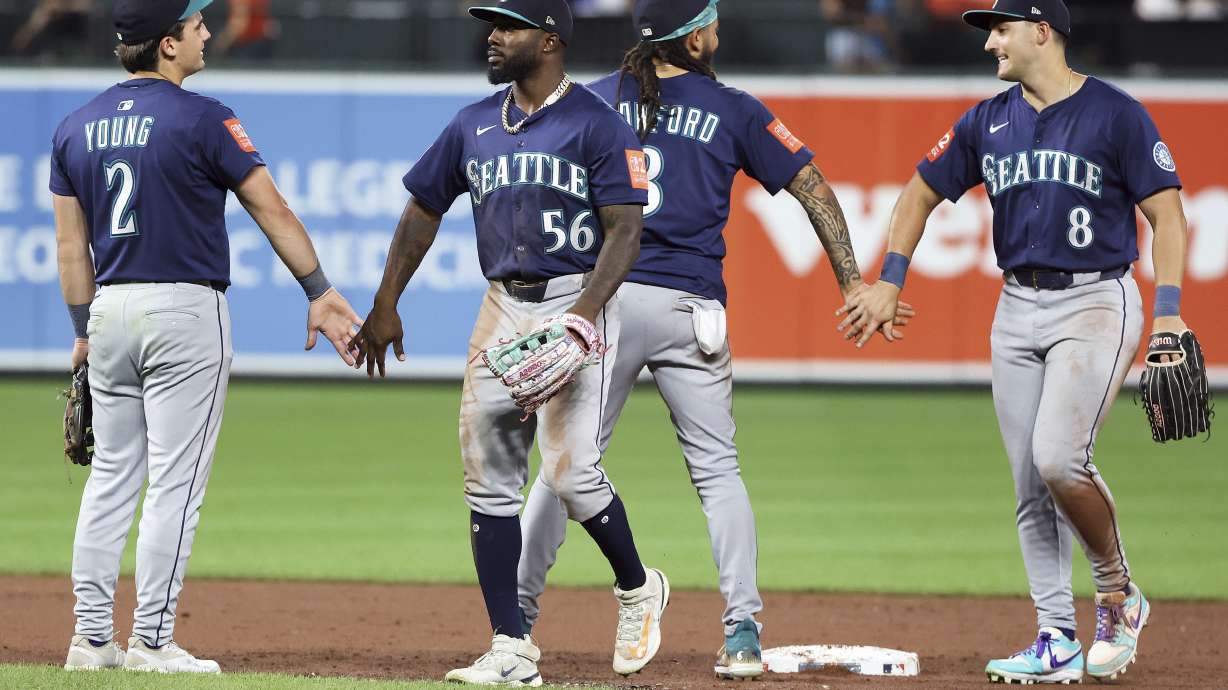 Seattle Mariners players celebrate after a game against the Baltimore Orioles, Tuesday, Aug. 12, 2025, in Baltimore.