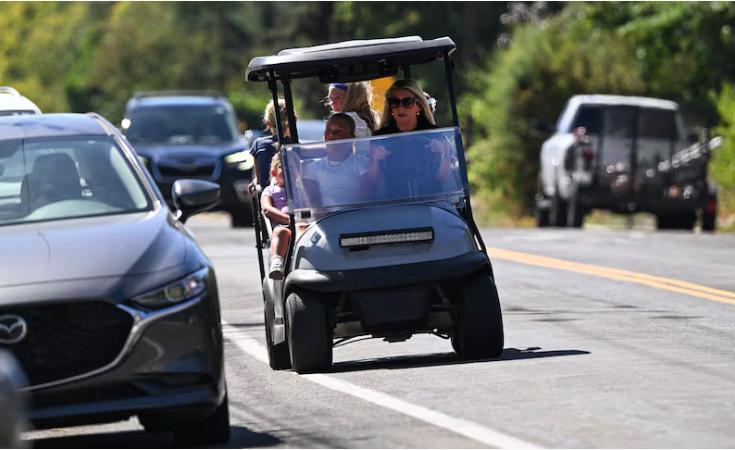 Lisa Healey drives the family golf cart to Holliday for some treats with her daughters Elle Healey, Winnifred Healey, Olivia Healey, Penelope Healey and niece Goldie Johnson in Millcreek on Tuesday.