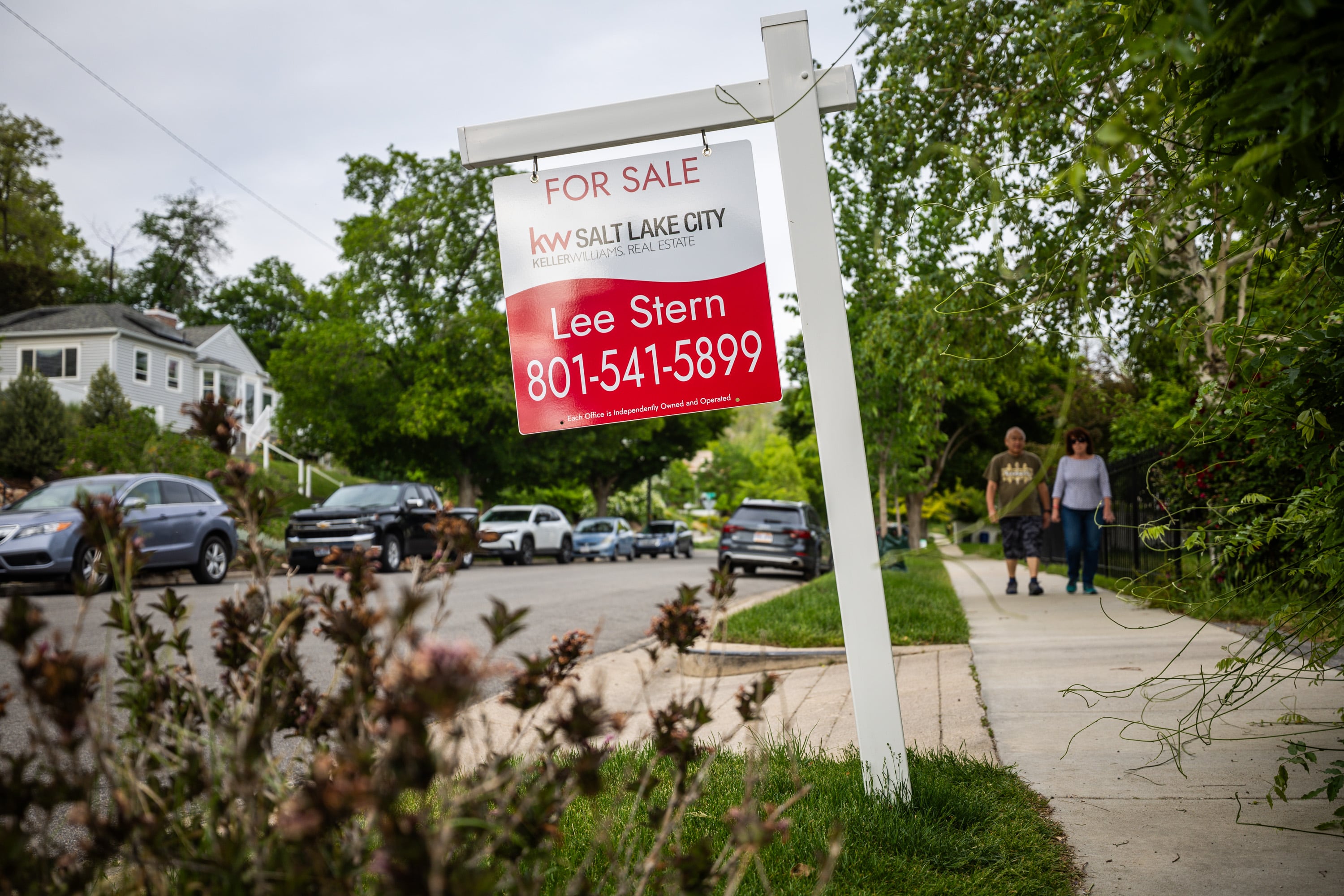 A for-sale sign is posted outside a house in the Avenues neighborhood in Salt Lake City on May 23. Mortgage rates and housing prices are slowly dropping, but homebuyers are still hesitant, Redfin real estate agent Katie Shook said Wednesday.